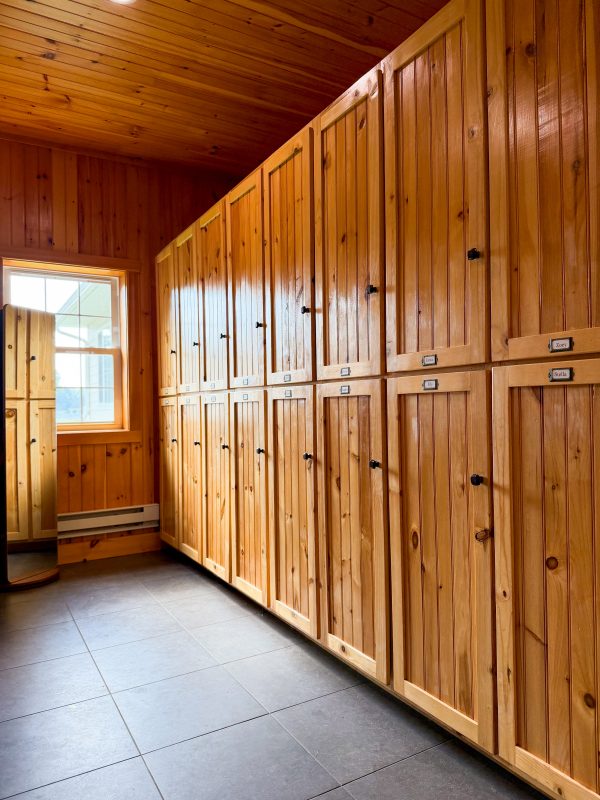 A wall of named tack lockers in the climate-controlled tack room